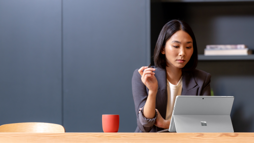 A woman using a Surface on a desk